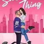 Illustrated cover in pink showing a city skyline in the background. A brown-haired, bearded hot white guy in a purple hockey jersey with the number 22 on it in long dark pants and ice skates, with a helmet and hockey stick on the nearby (pink) ice, is holding a pretty young white woman in jeans, a long sleeved white top and black booties. He's holding her just under the butt level on the sides and living her and she'd kicking her legs happily and embracing his face and neck, leaning toward him and smiling